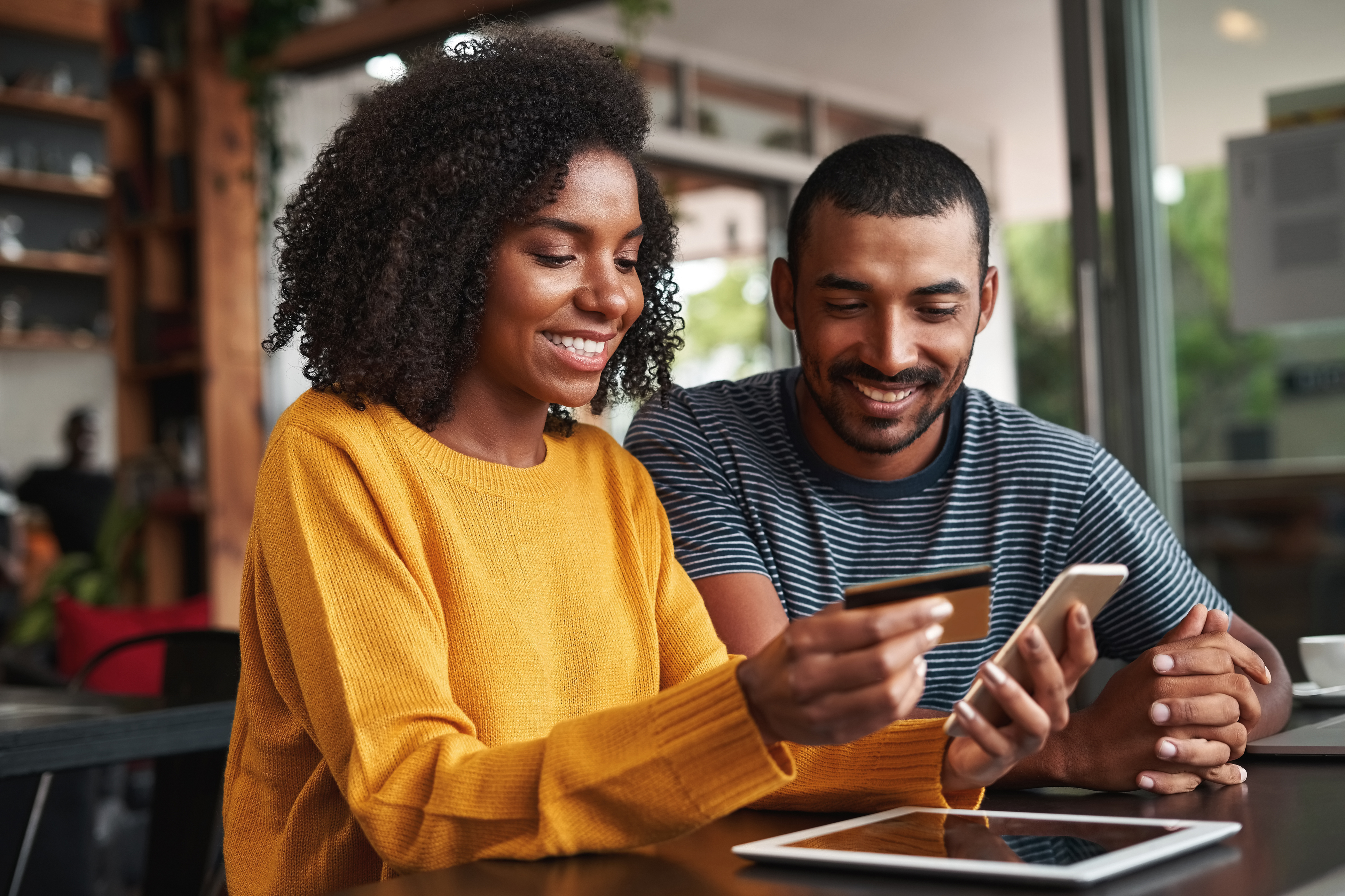 Couple paying a healthcare bill by phone with a credit card